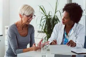 Photo of a woman consulting with an eye doctor.