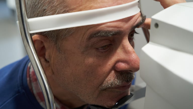 Image of an older gentlemen having OCT testing during a diabetic eye exam.